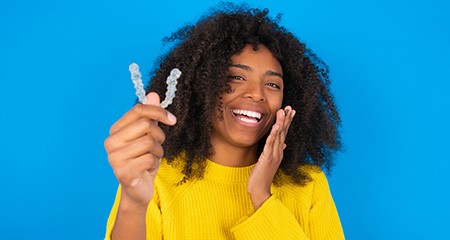 Patient in Gainesville smiling with their Invisalign aligners