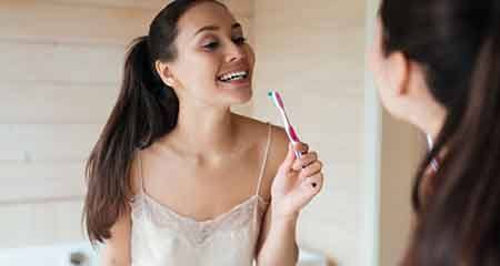 Woman holding a toothbrush