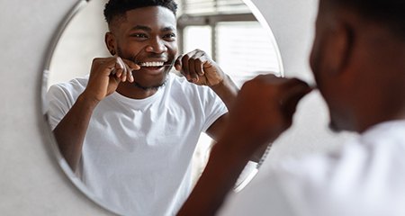 Patient and dentist smiling at each other during dental checkup