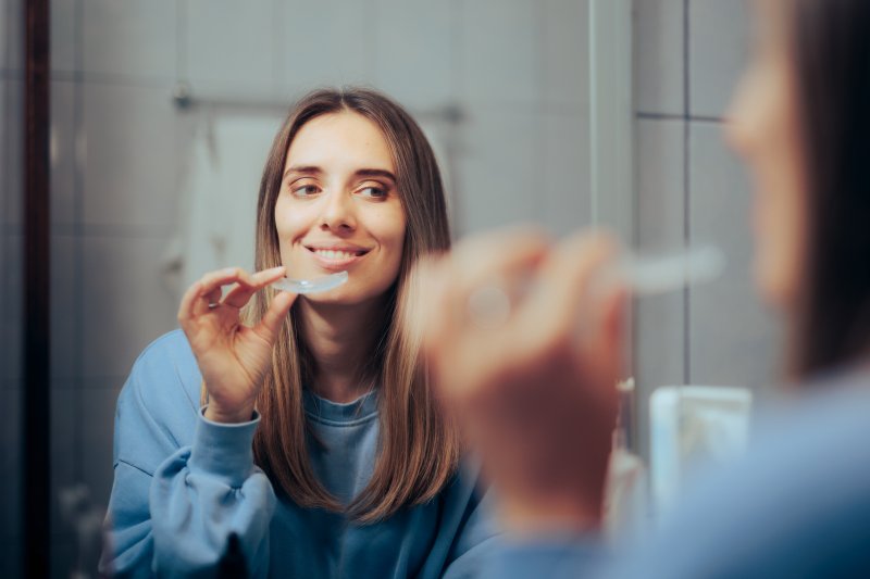 Patient putting in their Invisalign aligners